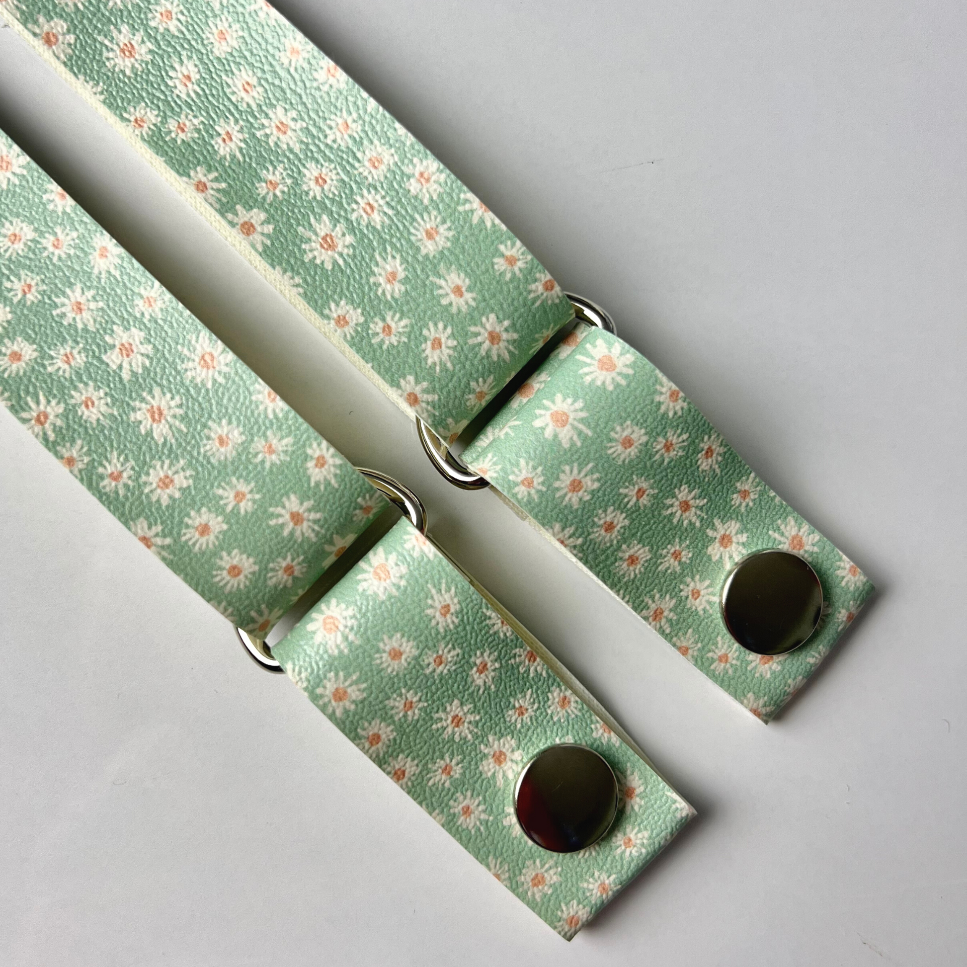 Sage & Daisy Strap - Vegan Leather: Embrace the serenity of nature with our Sage Daisies Strap, crafted from high-quality vegan leather. This design features delicate daisies on a soothing sage color backround, adding a touch of tranquility to your apron ensemble.